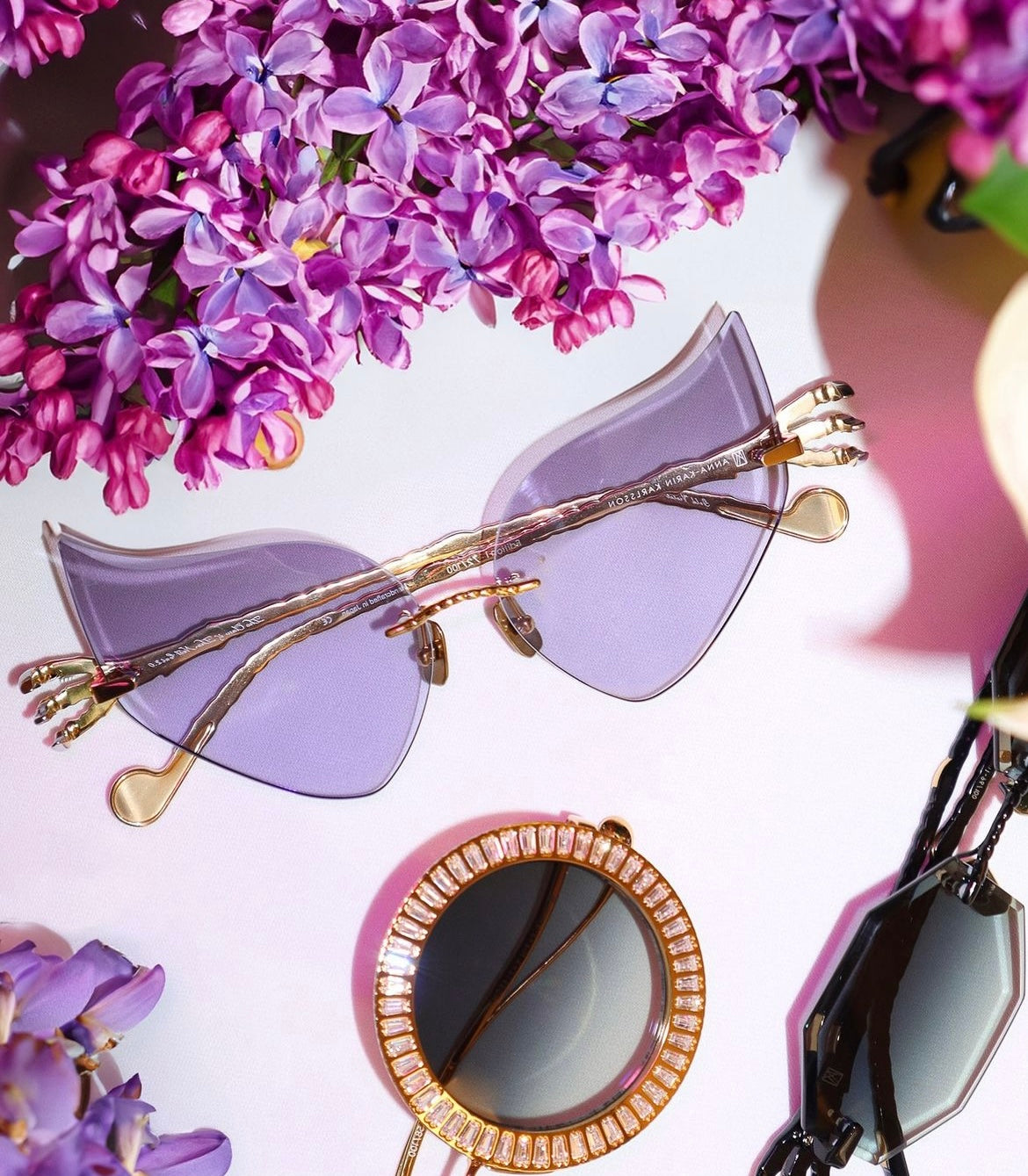 Limited edition Anna Karin Karlsson The Claw and the Nest Cat 2.0 in gold with purple lenses.  Anna Karin Karlsson available exclusively at I-Topian Optical Naples Luxury eyewear destination.